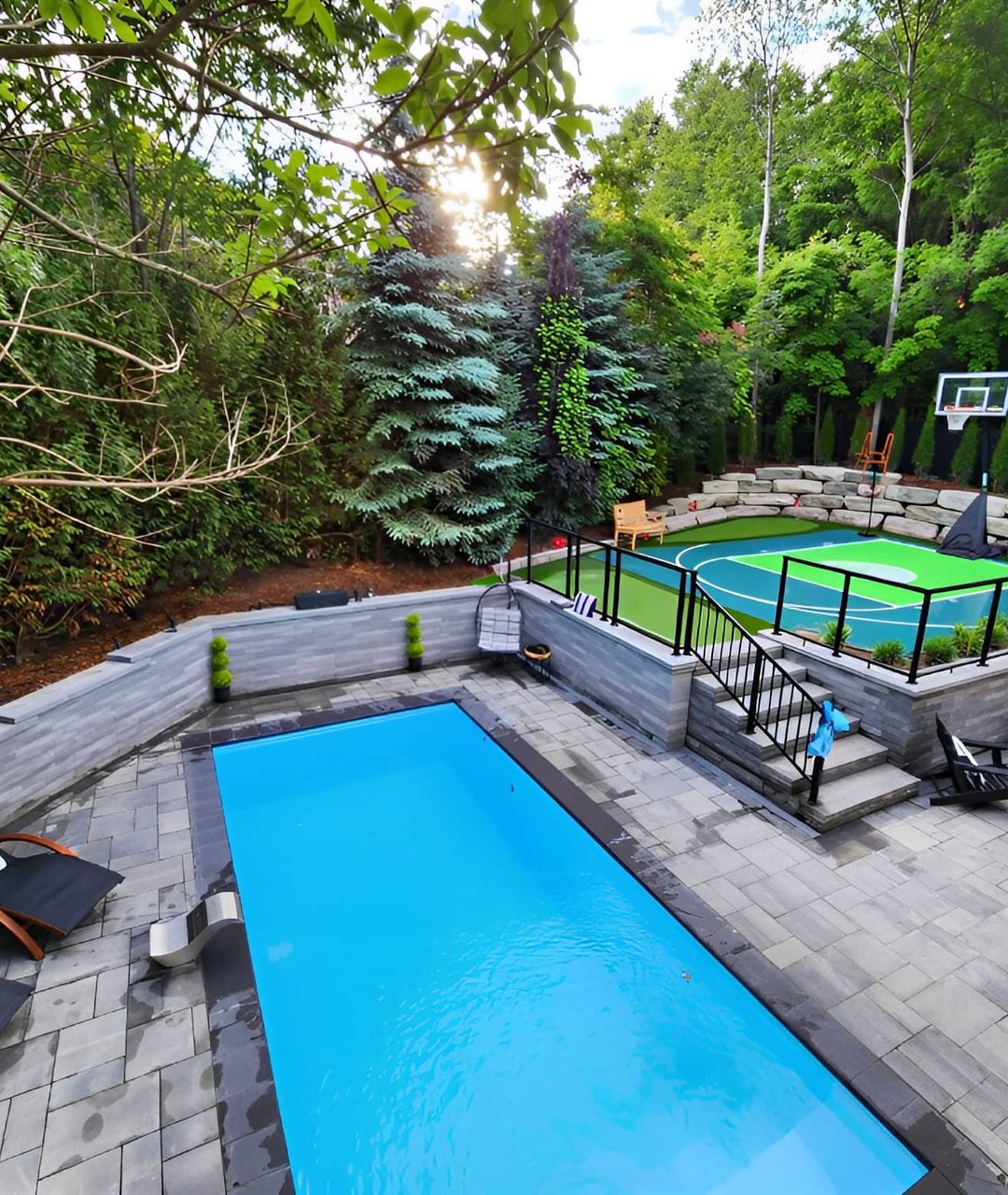 Hardscape construction around a custom backyard basketball court