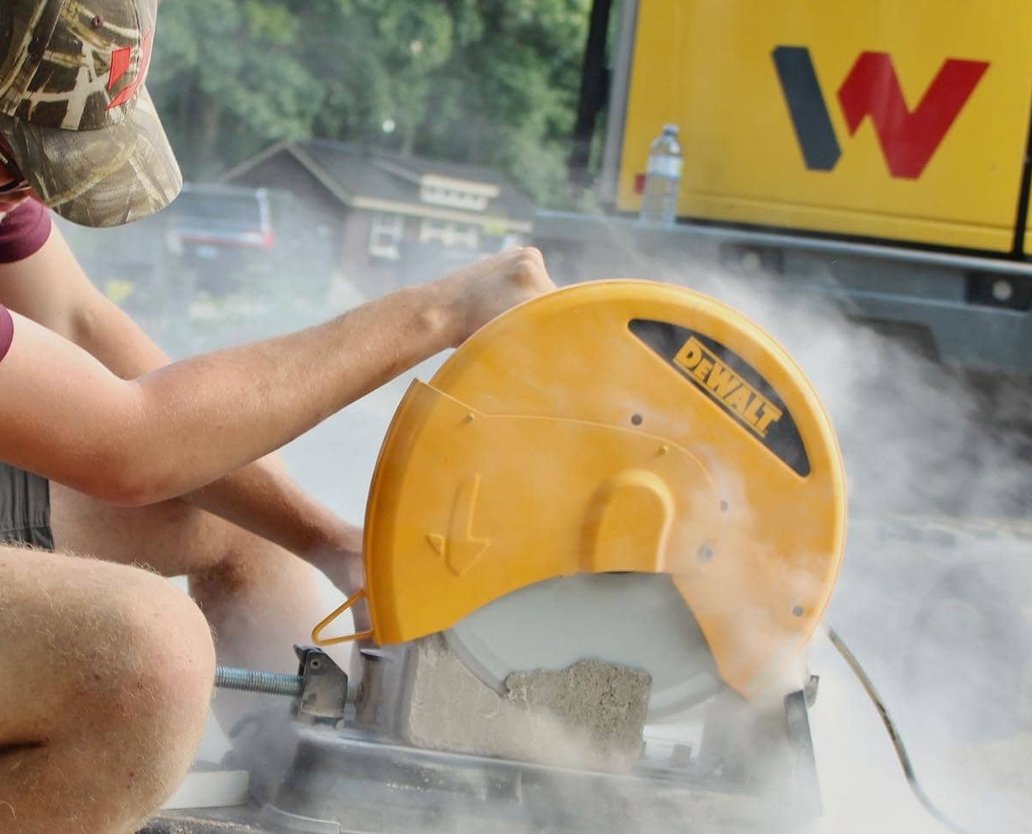 ExCL operator running a mini excavator on a residential site